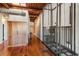 Industrial-style hallway featuring hardwood floors, wooden beams and an antique elevator at 490 Marietta St Nw # 307, Atlanta, GA 30313