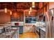 Stylish kitchen featuring stainless steel appliances, granite countertops, gray cabinets, and exposed brick accents at 490 Marietta St Nw # 307, Atlanta, GA 30313