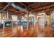 Open-concept floor plan with fireplace, modern kitchen, exposed brick, and hardwood floors at 490 Marietta St Nw # 307, Atlanta, GA 30313