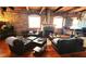 Cozy living room featuring a fireplace, leather seating, hardwood floors, and exposed brick walls at 490 Marietta St Nw # 307, Atlanta, GA 30313