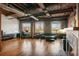 Open-concept living space with office, exposed brick walls, hardwood floors, and large windows at 490 Marietta St Nw # 307, Atlanta, GA 30313