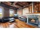 Bright living room featuring fireplace, hardwood floors, exposed brick, and large windows at 490 Marietta St Nw # 307, Atlanta, GA 30313