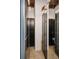 This walk-in closet includes custom storage and dark doors and is illuminated with stylish lighting at 490 Marietta St Nw # 307, Atlanta, GA 30313