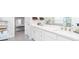 Bright bathroom featuring double sinks, storage, and a glimpse into an organized walk-in closet and vanity at 831 Corsiglia Farm Flts, Marietta, GA 30060