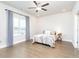 Serene bedroom with neutral tones, hardwood floors, a ceiling fan, and large window with natural light at 831 Corsiglia Farm Flts, Marietta, GA 30060