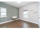 Bright bedroom with hardwood floors, a modern accent wall, and ample natural light at 831 Corsiglia Farm Flts, Marietta, GA 30060
