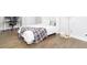 Cozy bedroom with a desk and chair, a comfortable bed, and hardwood floors at 831 Corsiglia Farm Flts, Marietta, GA 30060
