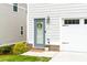 Charming home entrance with a blue door, a small garden, and well-manicured lawn at 831 Corsiglia Farm Flts, Marietta, GA 30060