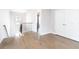 Bright hallway featuring hardwood floors, wooden railings, and natural light coming through a nearby window at 831 Corsiglia Farm Flts, Marietta, GA 30060