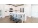 Modern kitchen with white cabinets, stainless steel appliances, and a quartz island with seating at 831 Corsiglia Farm Flts, Marietta, GA 30060