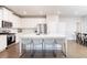 Modern kitchen with white cabinets, stainless steel appliances, and a quartz island with seating at 831 Corsiglia Farm Flts, Marietta, GA 30060