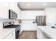 Bright kitchen featuring white cabinetry, stainless steel appliances, quartz countertops, and a subway tile backsplash at 831 Corsiglia Farm Flts, Marietta, GA 30060