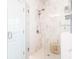 Luxurious shower with marble tile, a glass door, rainfall shower head, and built-in shelving for a spa-like experience at 831 Corsiglia Farm Flts, Marietta, GA 30060