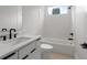 Modern bathroom with white cabinets, black hardware, and tiled walls at 1186A Francis Nw St, Atlanta, GA 30318