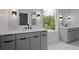 The bright bathroom has dual vanities with modern fixtures and offers plenty of natural light at 1186A Francis Nw St, Atlanta, GA 30318