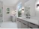 The bright bathroom features double vanities, modern fixtures, and a large window offering natural light at 1186A Francis Nw St, Atlanta, GA 30318