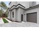 Exterior view of a modern home with a gray garage door and stone driveway at 1186A Francis Nw St, Atlanta, GA 30318