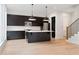 Stylish kitchen with dark cabinets, a center island, and stainless steel appliances at 1186A Francis Nw St, Atlanta, GA 30318