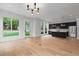 Modern kitchen and living area with hardwood floors, black cabinets, and stainless appliances at 1186A Francis Nw St, Atlanta, GA 30318