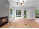 Sunlit living room showcases hardwood floors, a modern fireplace, and outdoor views at 1186A Francis Nw St, Atlanta, GA 30318