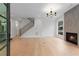 Bright, open-concept living room with a fireplace, hardwood floors, and staircase at 1186A Francis Nw St, Atlanta, GA 30318