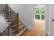 A modern staircase features light wood treads and black iron railings, providing an airy, open feel at 1186A Francis Nw St, Atlanta, GA 30318