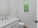 Modern bathroom featuring vanity with sink, toilet, and natural light at 1186B Francis Nw St, Atlanta, GA 30318