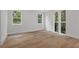 Bright bedroom with hardwood floors and large windows offering serene views of the surrounding greenery at 1186B Francis Nw St, Atlanta, GA 30318