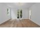 Sun-filled bedroom boasts beautiful hardwood floors, a modern light fixture, and large windows at 1186B Francis Nw St, Atlanta, GA 30318