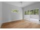 Bright bedroom featuring hardwood floors, white walls, and sliding glass doors to the outdoor deck at 1186B Francis Nw St, Atlanta, GA 30318