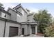 Modern home with gray siding, black trim, a two-car garage, and professional landscaping at 1186B Francis Nw St, Atlanta, GA 30318