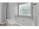 Bathroom featuring a corner tub beneath a window, providing natural light at 3822 River Ridge Ct, Decatur, GA 30034