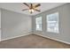 Bedroom features two large windows with a ceiling fan and neutral carpeting at 3822 River Ridge Ct, Decatur, GA 30034