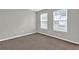 Bedroom with neutral carpet and paint, two windows and a baseboard at 3822 River Ridge Ct, Decatur, GA 30034