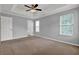Bedroom features plush carpeting, a tray ceiling, and lots of natural light at 3822 River Ridge Ct, Decatur, GA 30034