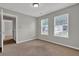 A well-lit bedroom featuring neutral walls, carpet flooring, and windows at 3822 River Ridge Ct, Decatur, GA 30034