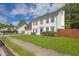 Charming two-story home with a well-manicured lawn, framed by trees and blue skies at 3822 River Ridge Ct, Decatur, GA 30034