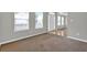 Carpeted living room featuring windows with blinds and a glimpse of other rooms at 3822 River Ridge Ct, Decatur, GA 30034