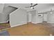 Open-concept living room features wood floors, a ceiling fan, and staircase access at 3822 River Ridge Ct, Decatur, GA 30034