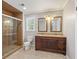 Bathroom featuring a double vanity, tiled floor, glass shower, and modern fixtures at 4179 Westchester Ne Xing, Roswell, GA 30075