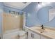 A full bathroom with a tub/shower combination, a beige vanity and blue walls at 4179 Westchester Ne Xing, Roswell, GA 30075