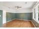 Bedroom with wainscoting, hardwood floors, a ceiling fan, and natural light from a window at 4179 Westchester Ne Xing, Roswell, GA 30075