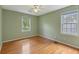 Bedroom featuring hardwood floors, a ceiling fan, and natural light from two windows at 4179 Westchester Ne Xing, Roswell, GA 30075