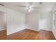 A well-lit bedroom shows hardwood floors, a ceiling fan and closet at 4179 Westchester Ne Xing, Roswell, GA 30075