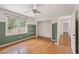 Bedroom with hardwood floors and olive green accent wall leading into hall at 4179 Westchester Ne Xing, Roswell, GA 30075