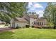 Charming home exterior with lush lawn, a wooden deck, and a convenient two-car garage at 4179 Westchester Ne Xing, Roswell, GA 30075