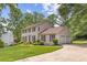 Two-story home with a lush front lawn and a driveway leading to the two-car garage at 4179 Westchester Ne Xing, Roswell, GA 30075