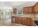 Eat-in kitchen with wood cabinets, granite counters, stainless steel dishwasher and tiled backsplash at 4179 Westchester Ne Xing, Roswell, GA 30075