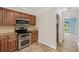Well-equipped kitchen featuring stainless steel appliances and wood cabinets at 4179 Westchester Ne Xing, Roswell, GA 30075
