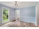 Open living room with wood floors, natural light, and front door access at 4179 Westchester Ne Xing, Roswell, GA 30075